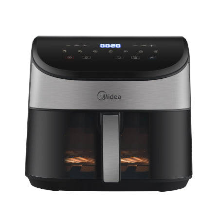 A lit-up view through the Midea air fryer's transparent window while cooking, allowing for easy monitoring without losing heat.