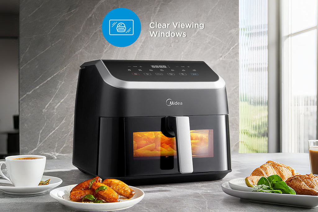 Internal light illuminating the 8.5L Midea MF-CY85WK2 air fryer basket through the observation window during cooking.